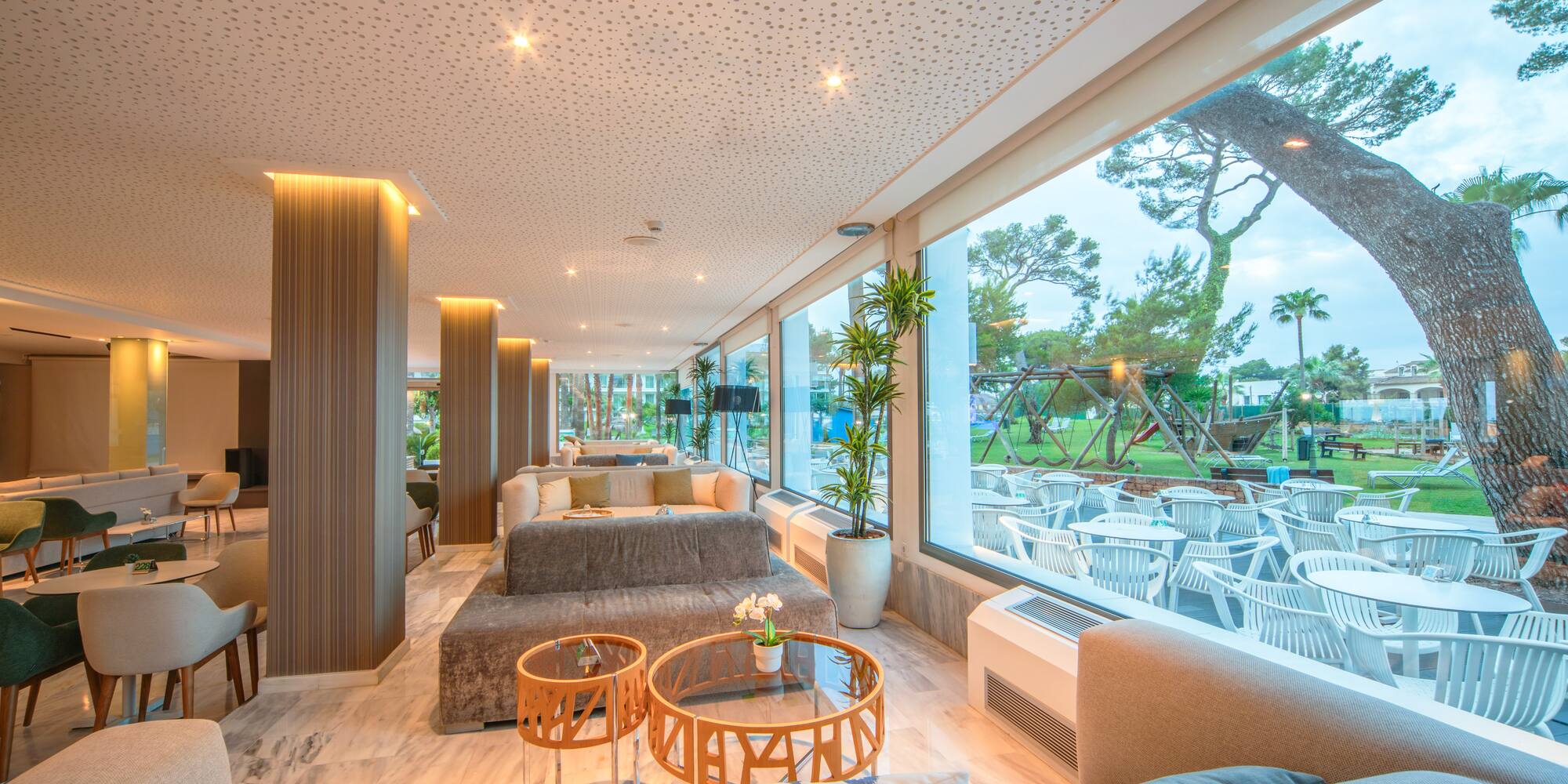 a room with a large window and a large table and chairs