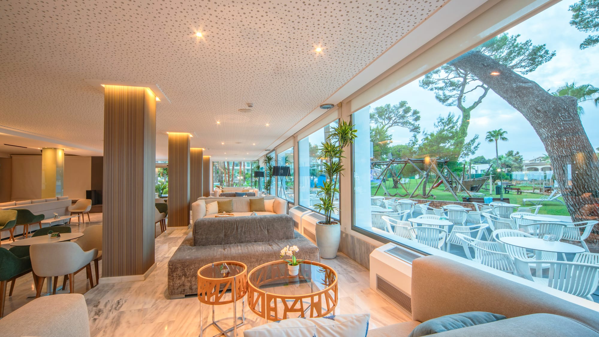 a room with a large window and a large table and chairs