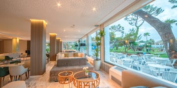 a room with a large window and a large table and chairs