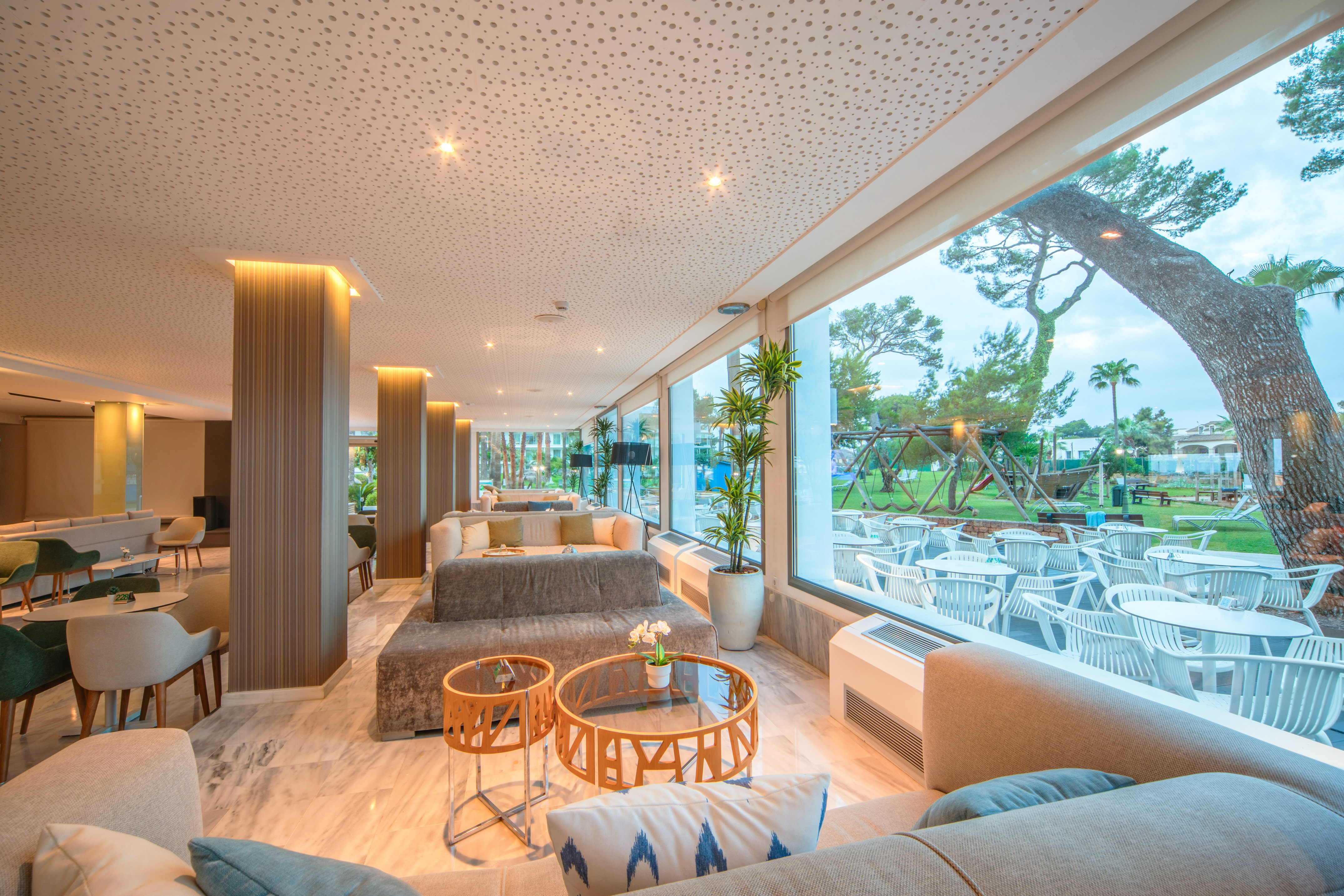 a room with a large window and a large table and chairs