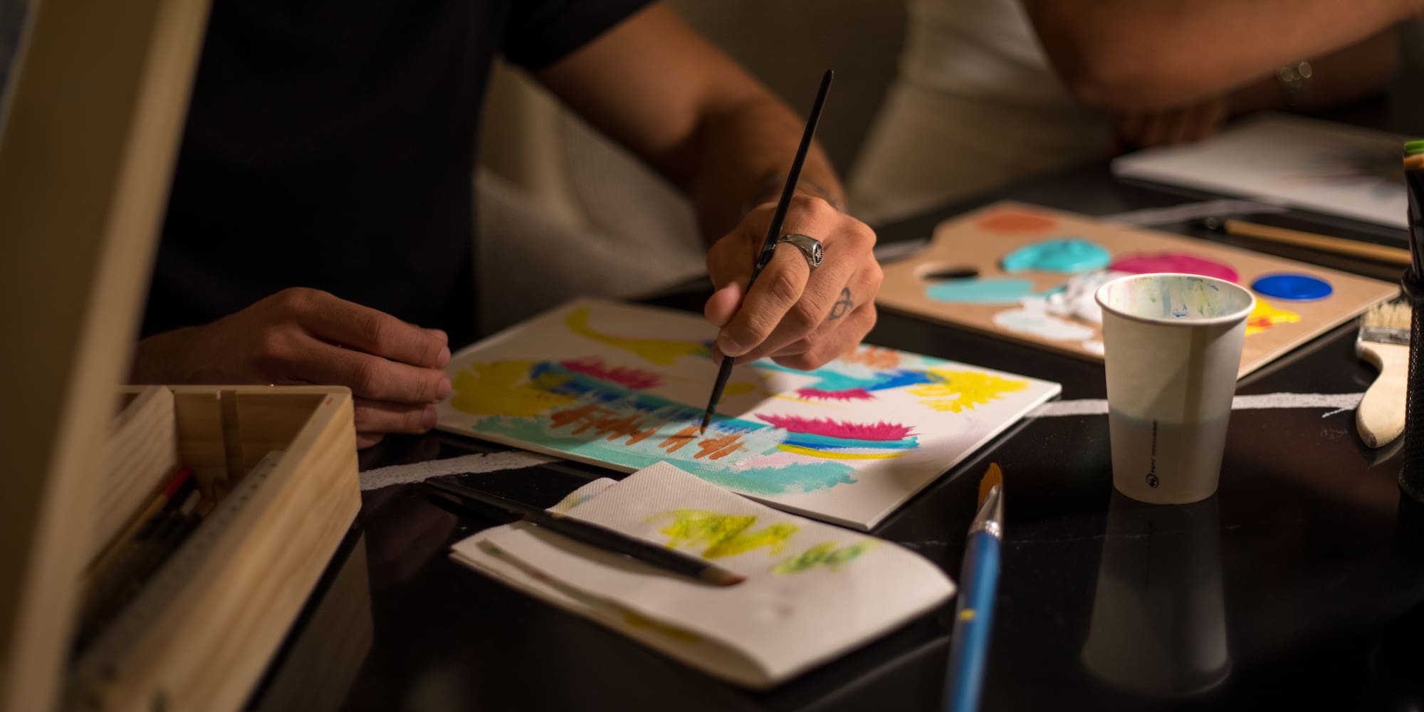 a person painting on a paper