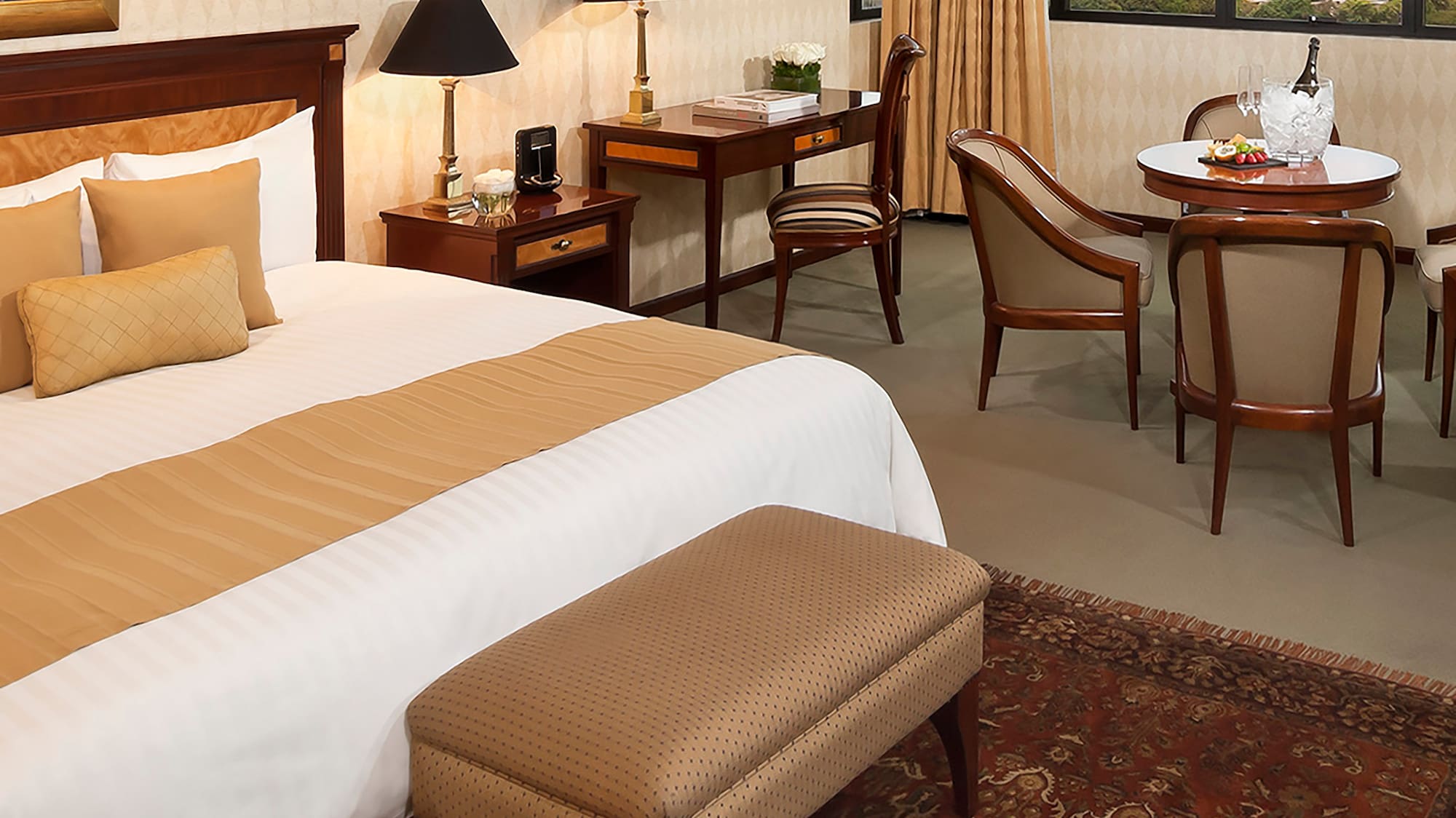 a room with a bed and chairs and a table