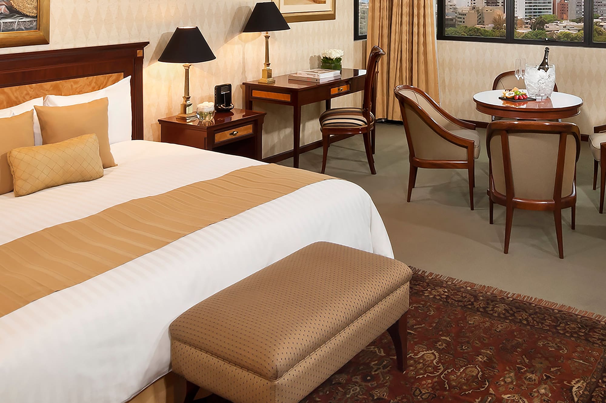 a room with a bed and chairs and a table