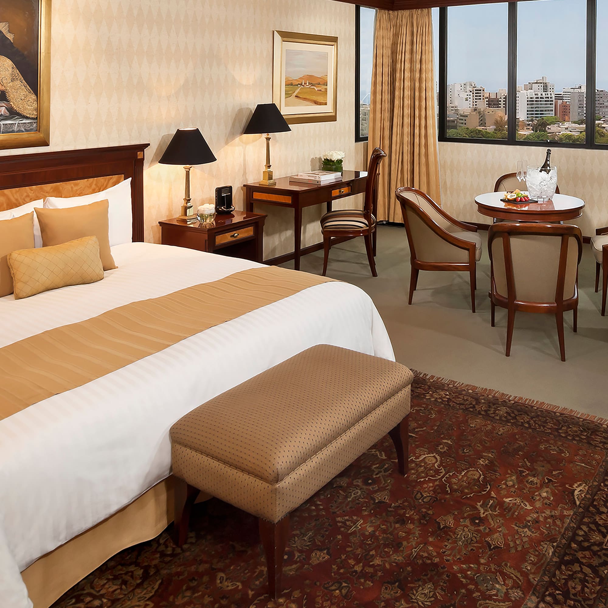 a room with a bed and chairs and a table