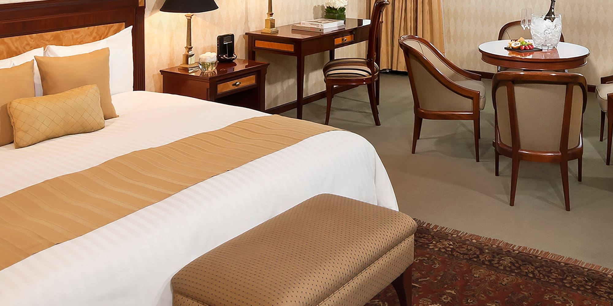 a room with a bed and chairs and a table