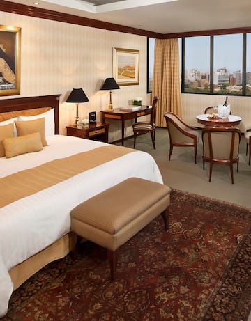 a room with a bed and chairs and a table