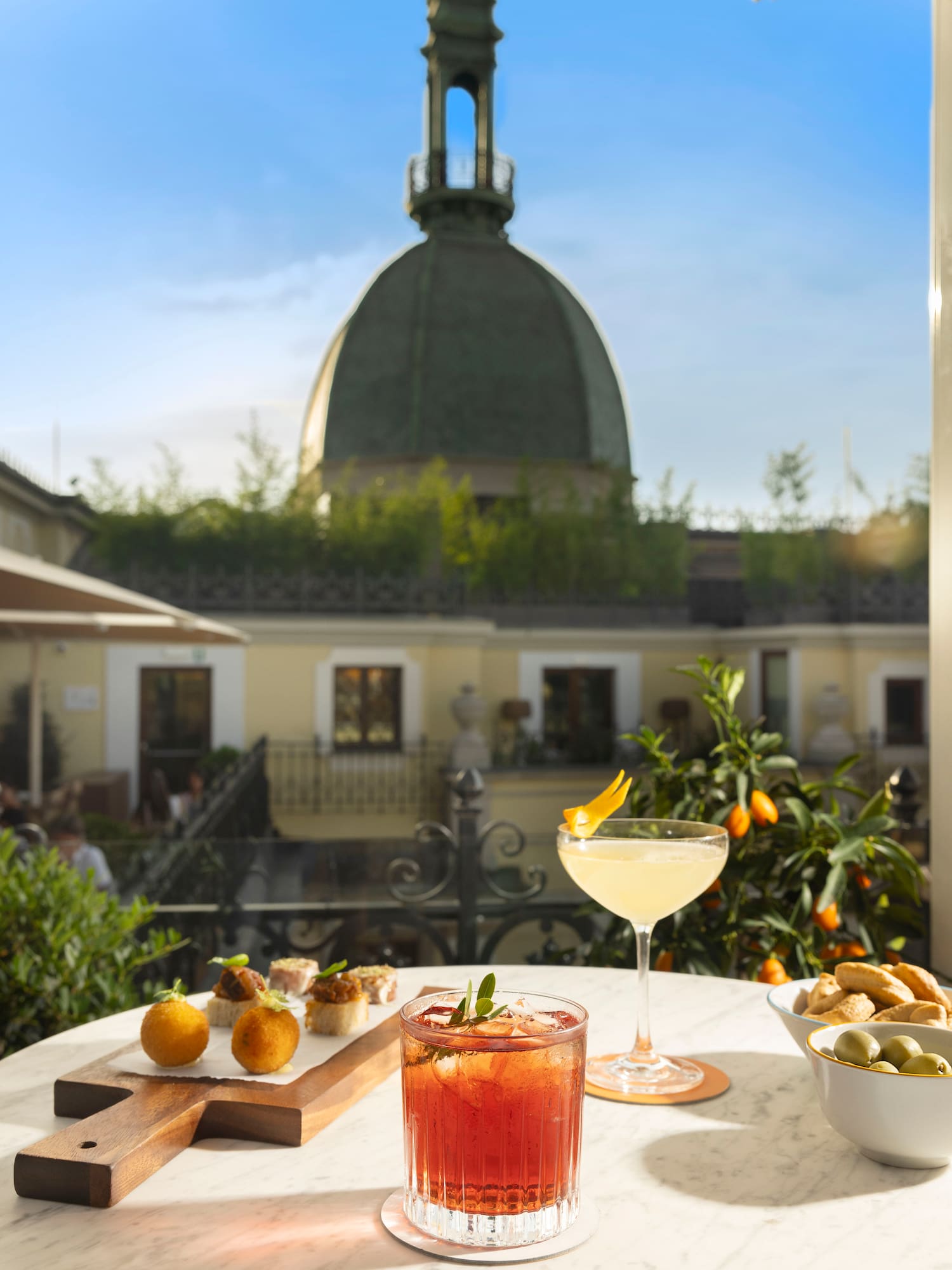 a table with food on it and a glass of drink on it