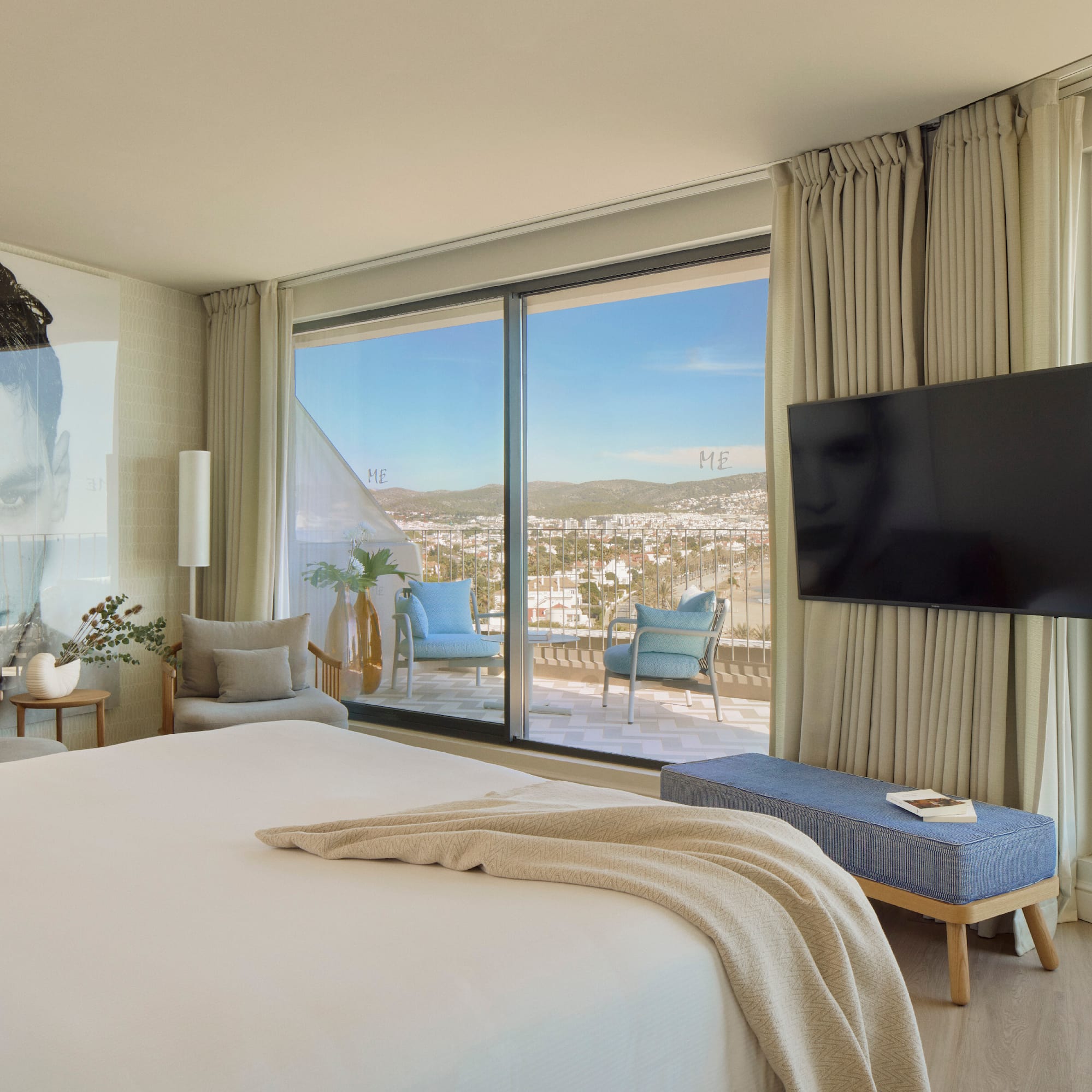 a bedroom with a large window and a large bed