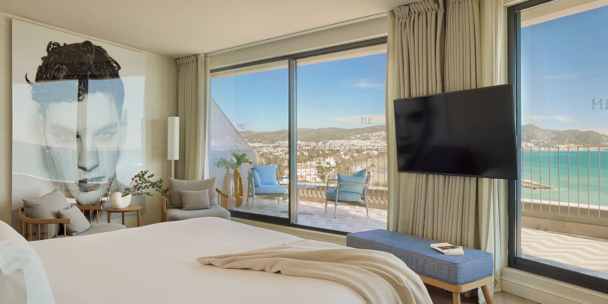 a bedroom with a large window and a large bed