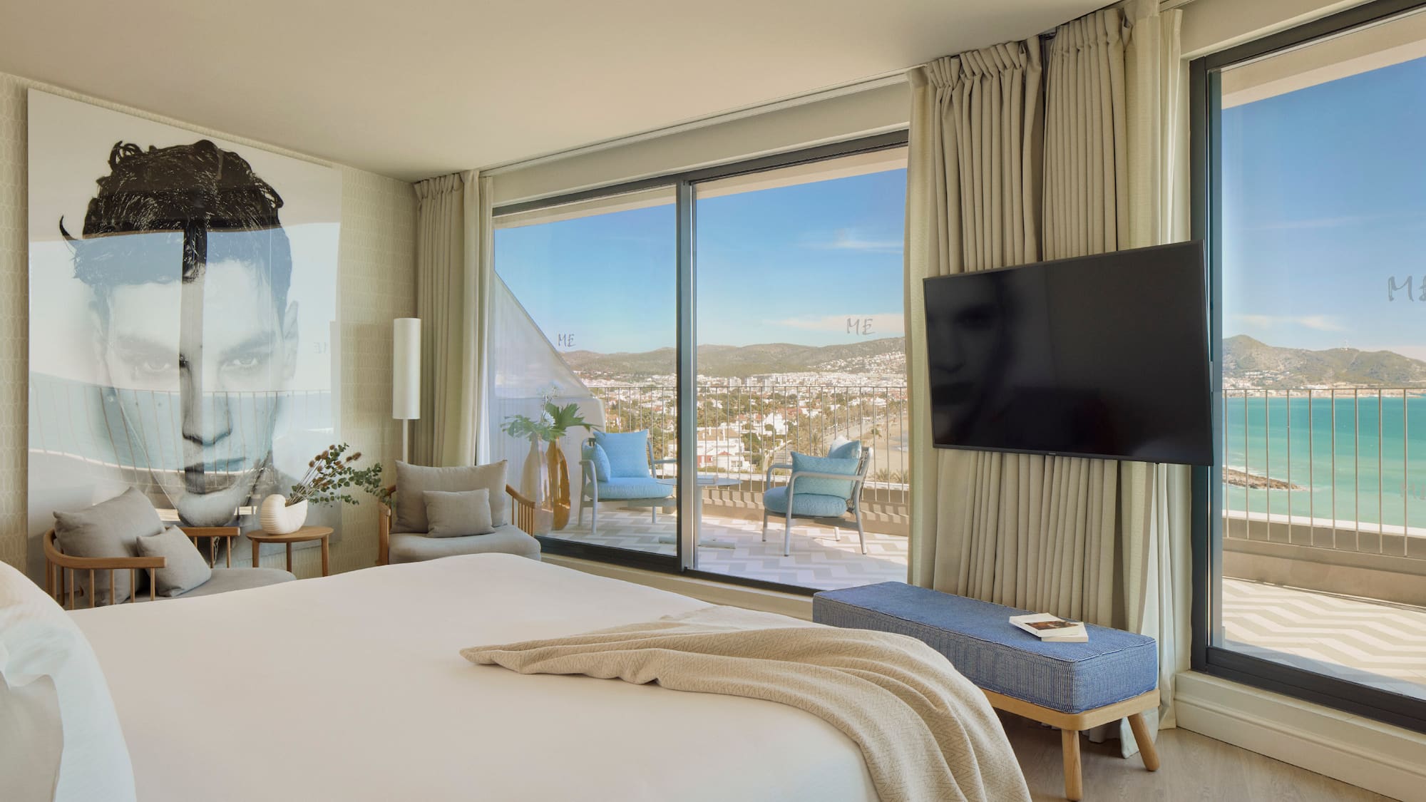 a bedroom with a large window and a large bed