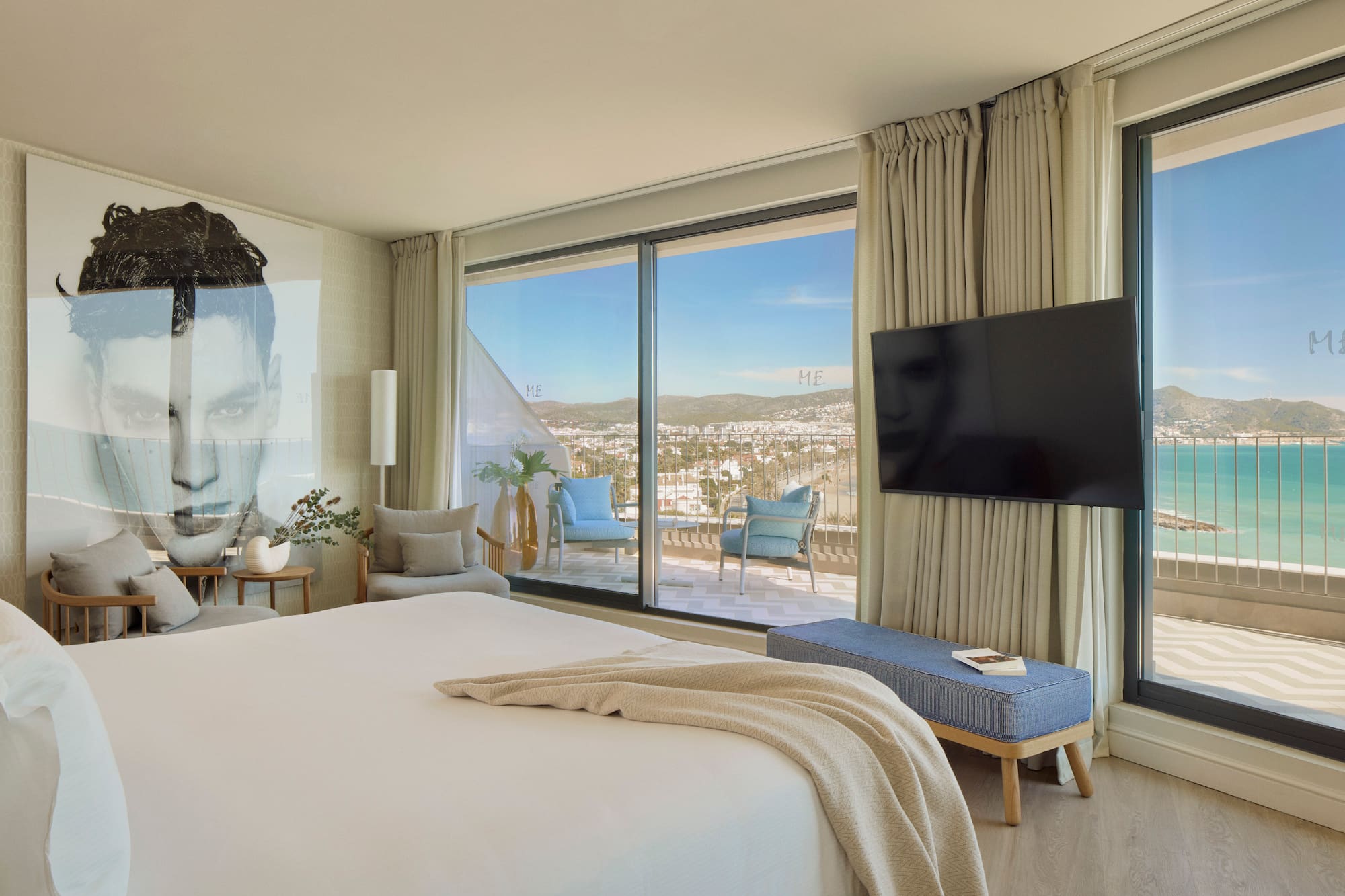 a bedroom with a large window and a large bed