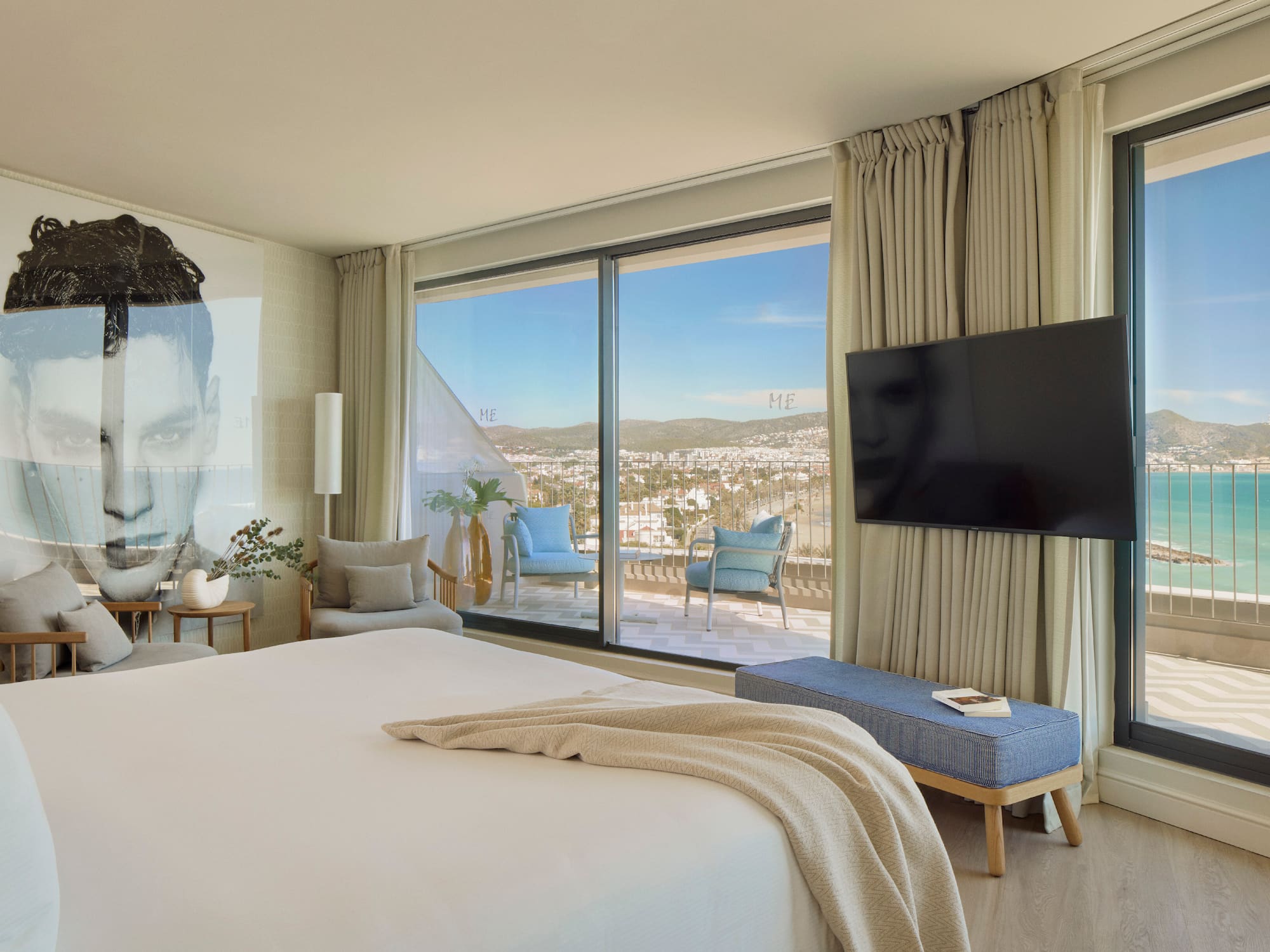 a bedroom with a large window and a large bed