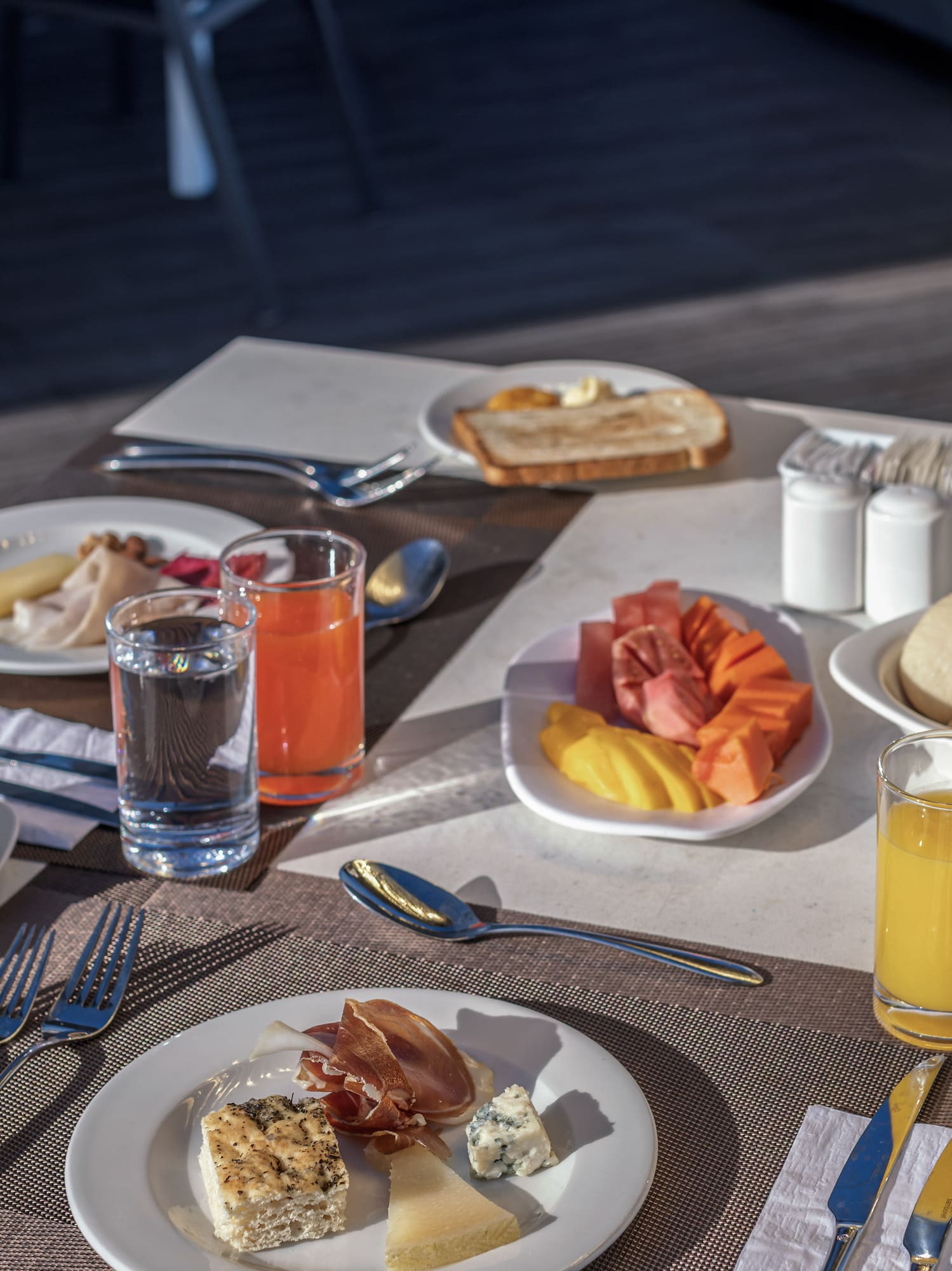 a table with plates of food and glasses