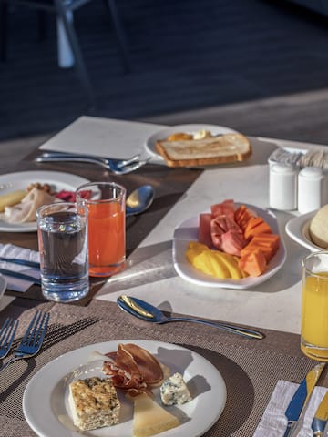 a table with plates of food and glasses