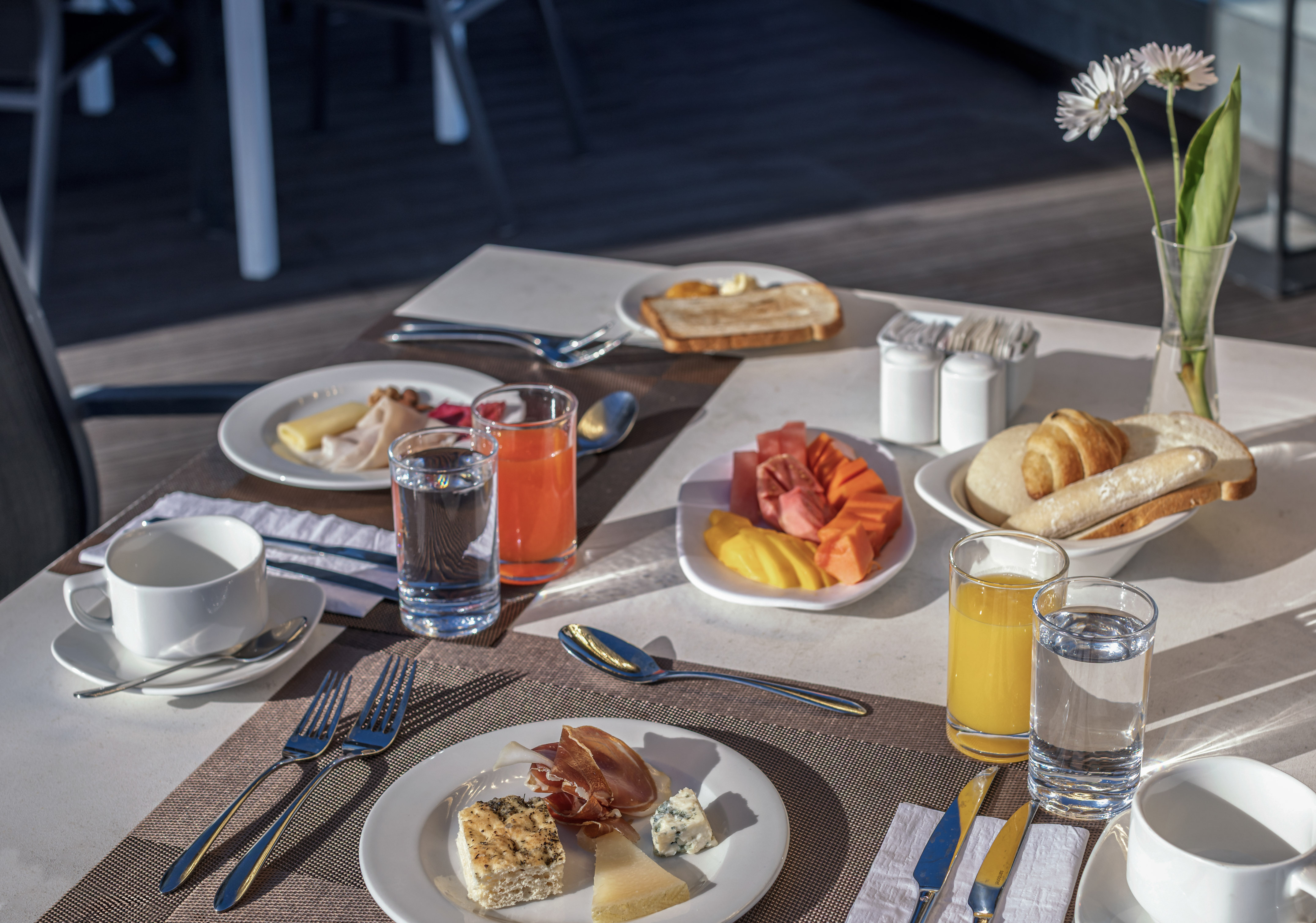 a table with plates of food and glasses
