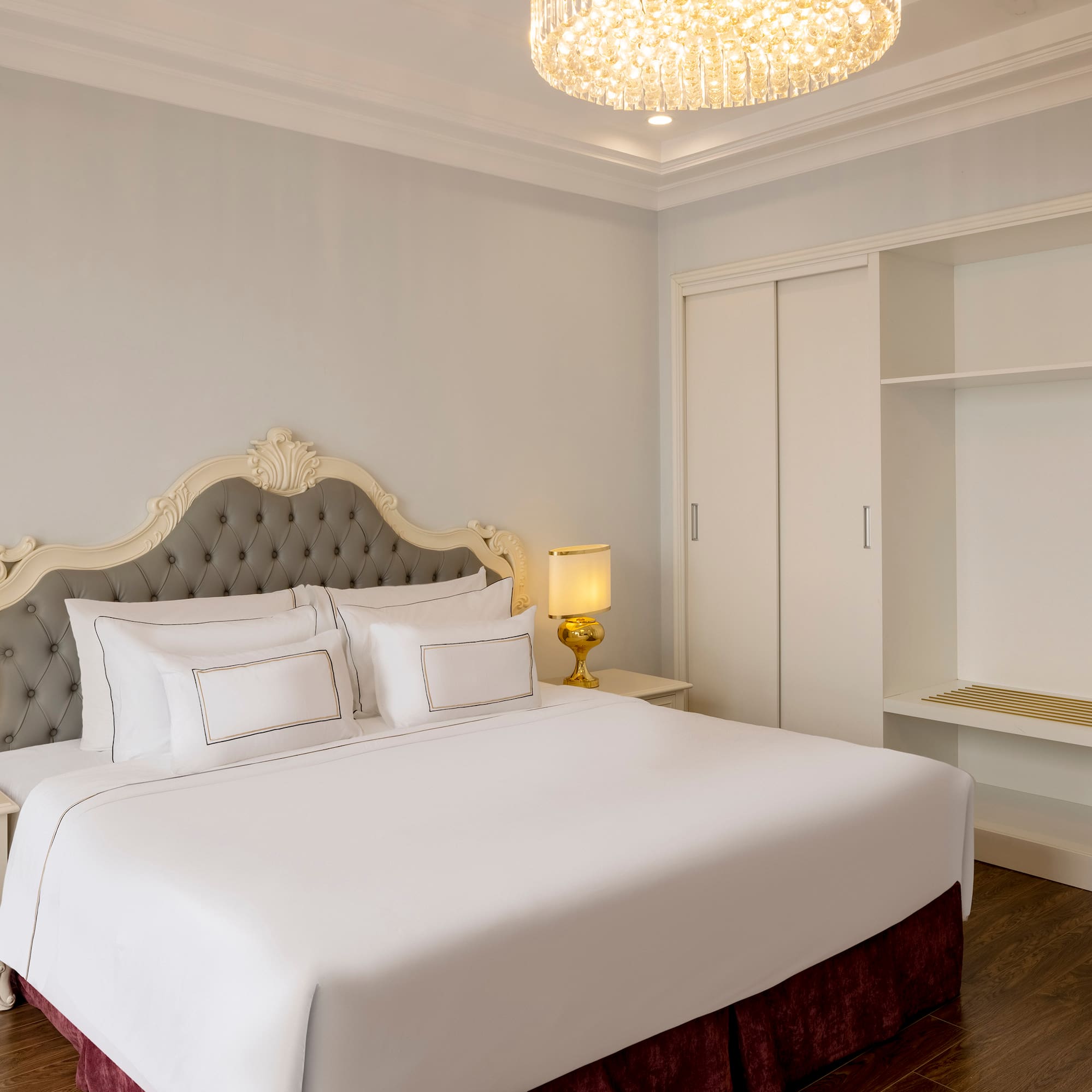 a bed with a chandelier in the middle