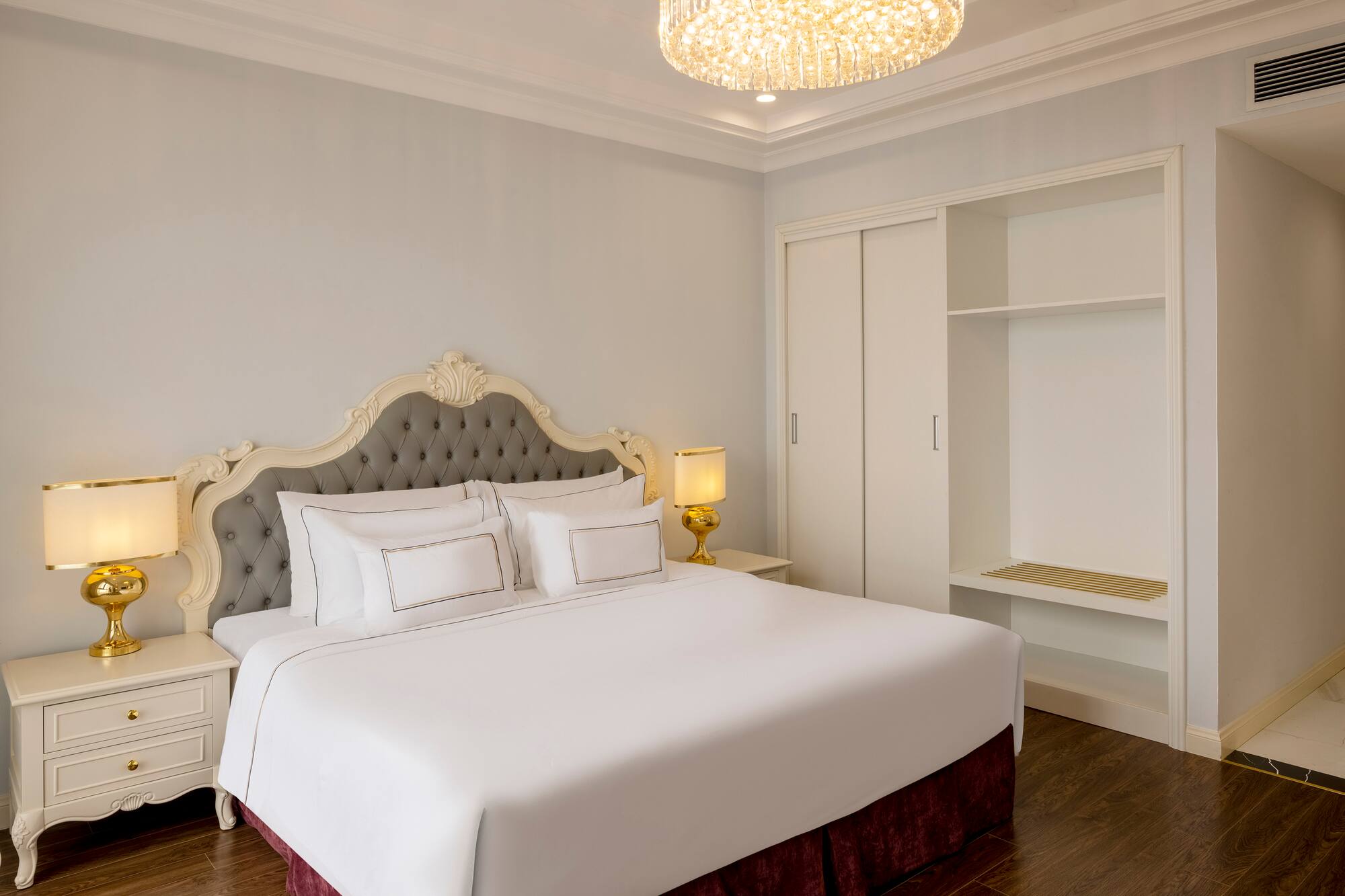 a bed with a chandelier in the middle