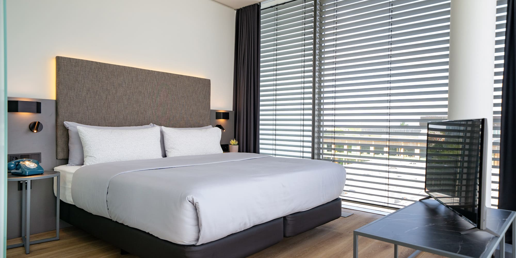 a bed with a tv in a room