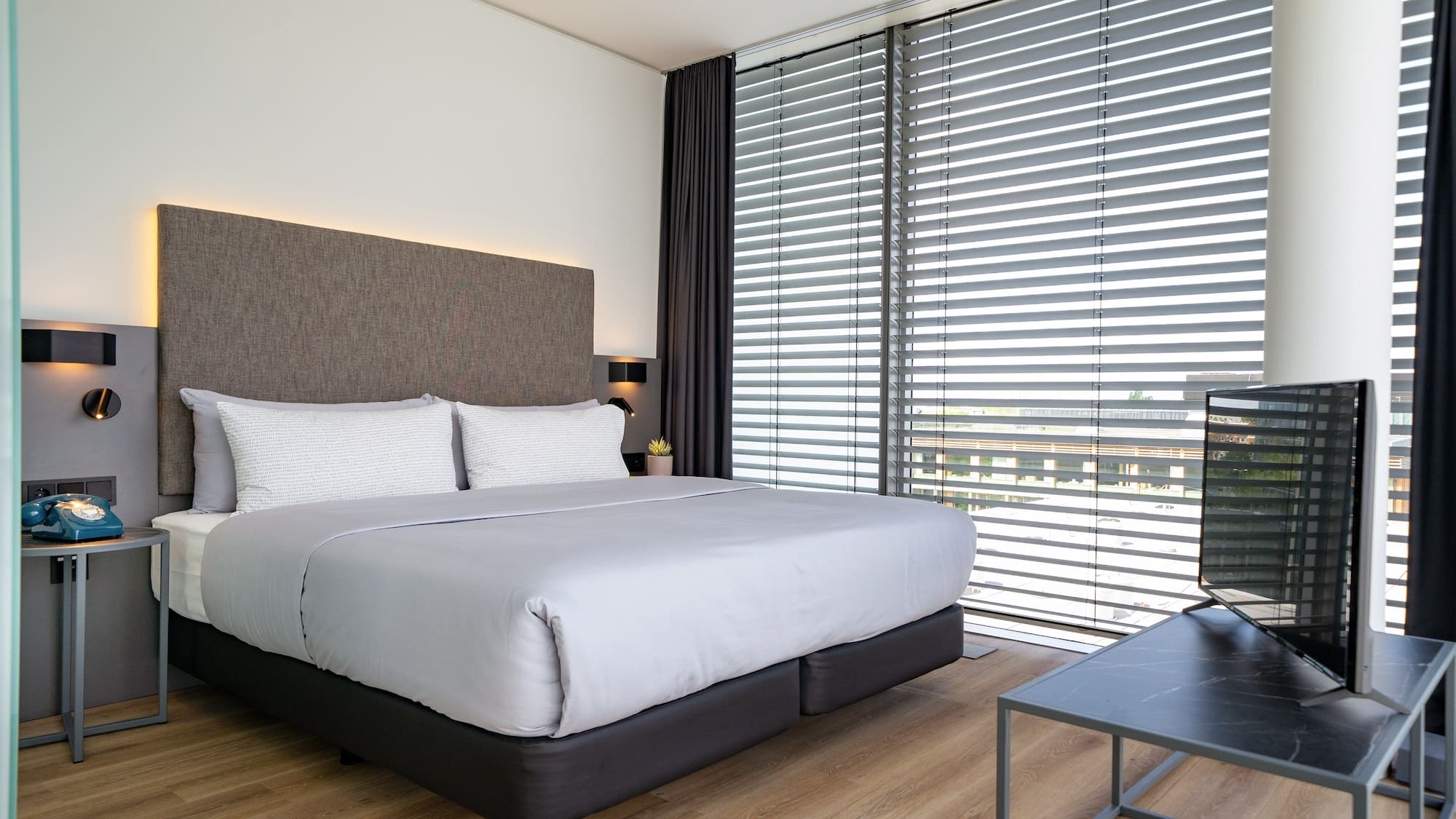 a bed with a tv in a room