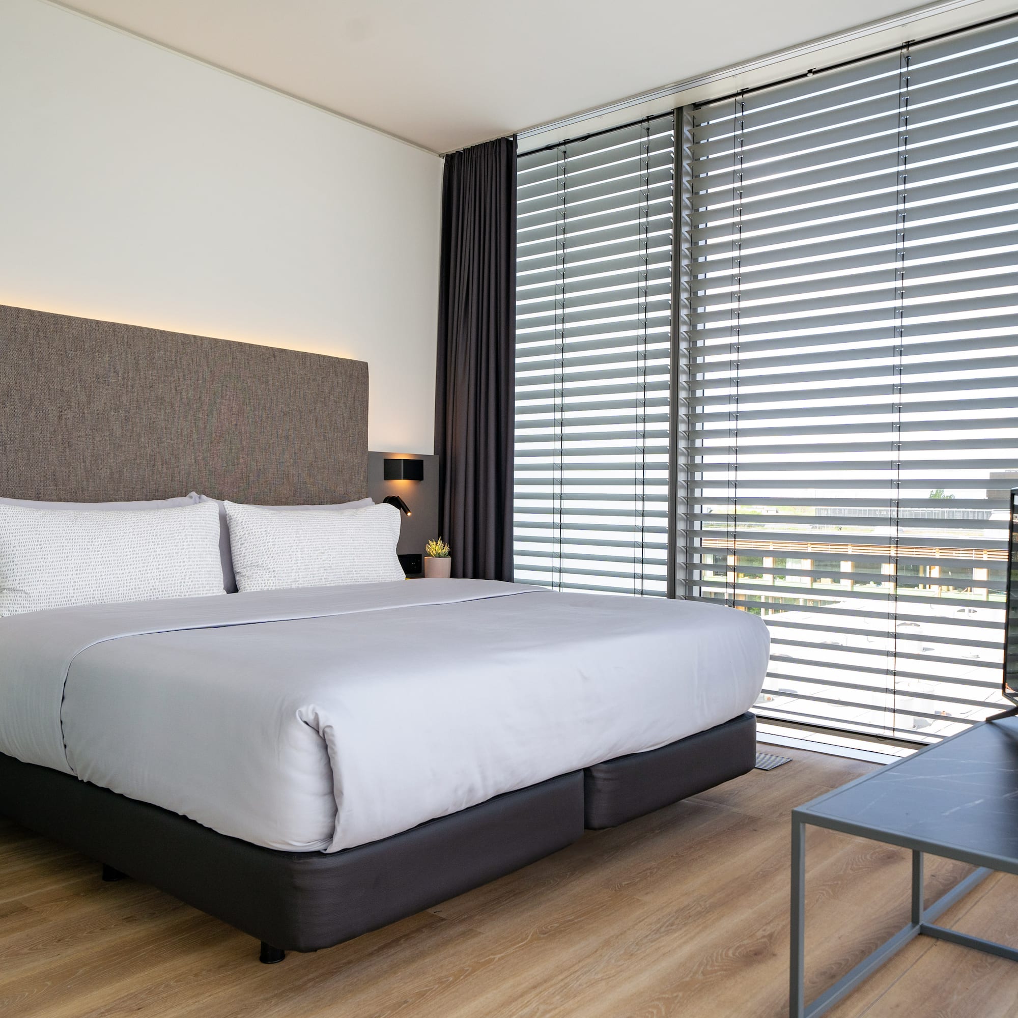 a bed with a tv in a room