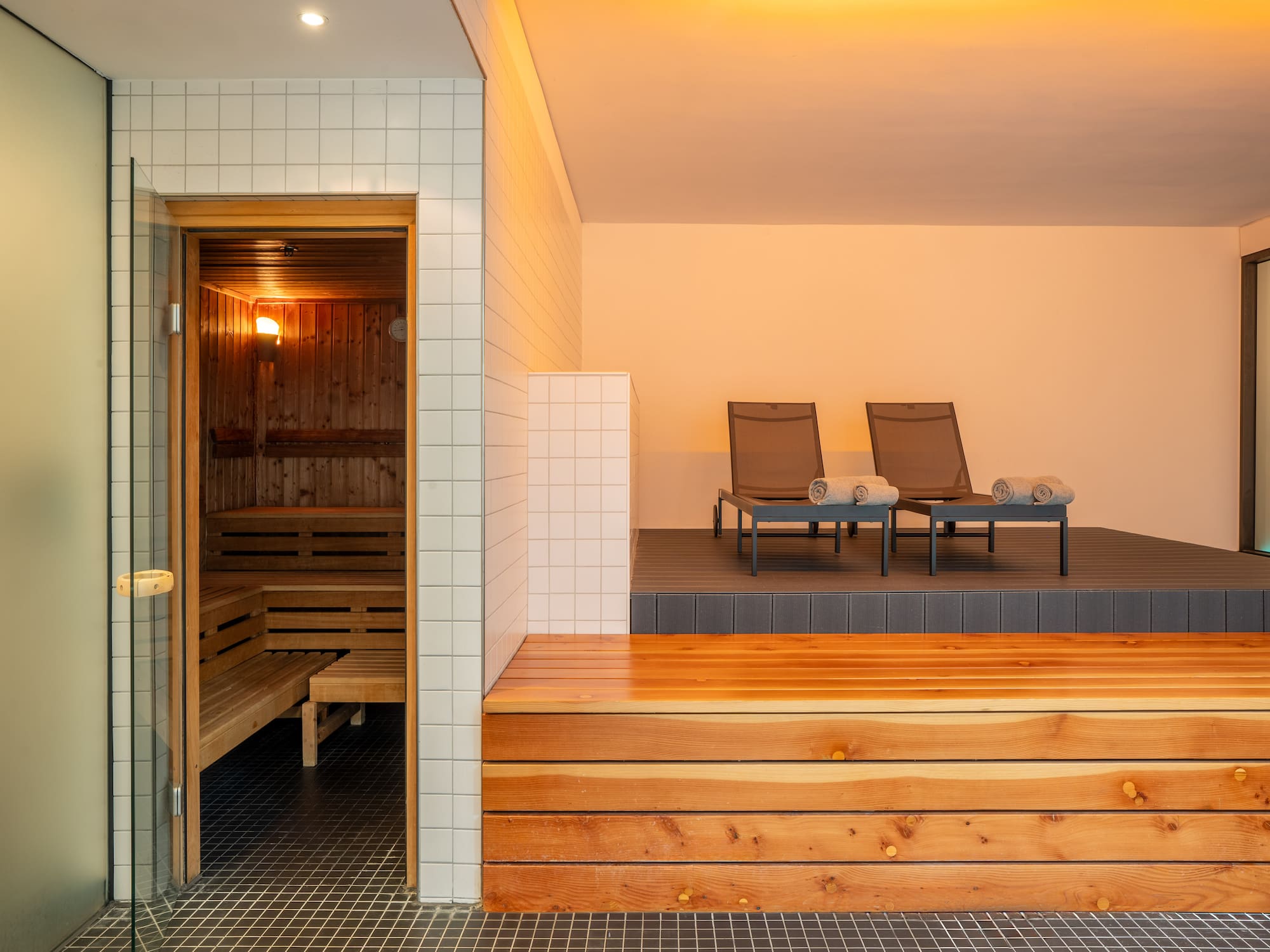 a sauna with chairs in the background