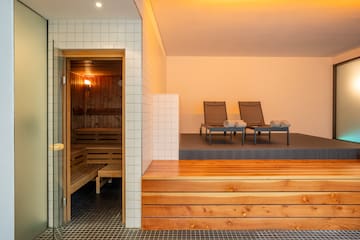 a sauna with chairs in the background
