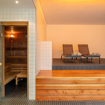 a sauna with chairs in the background