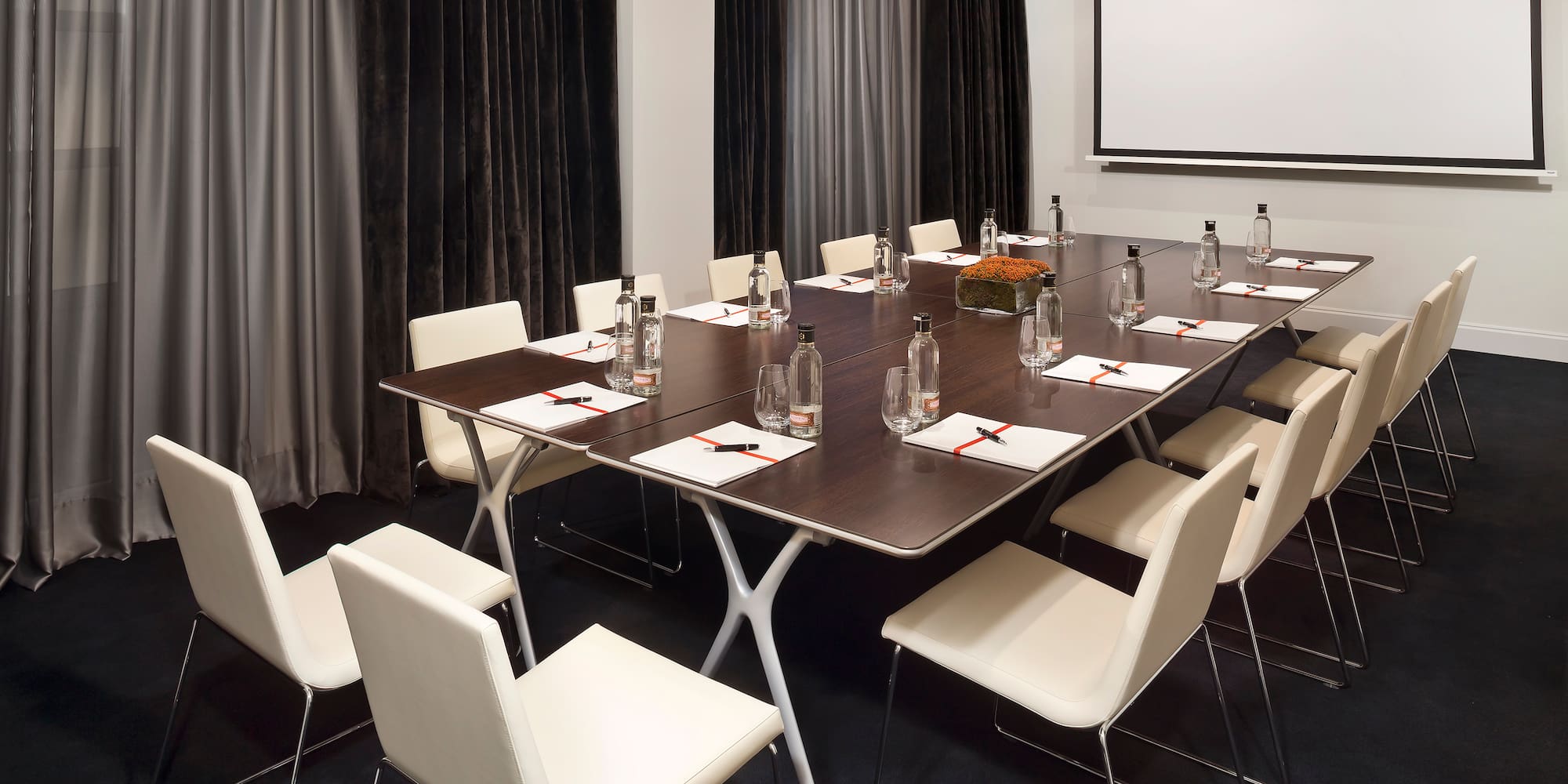 a conference room with a table and chairs