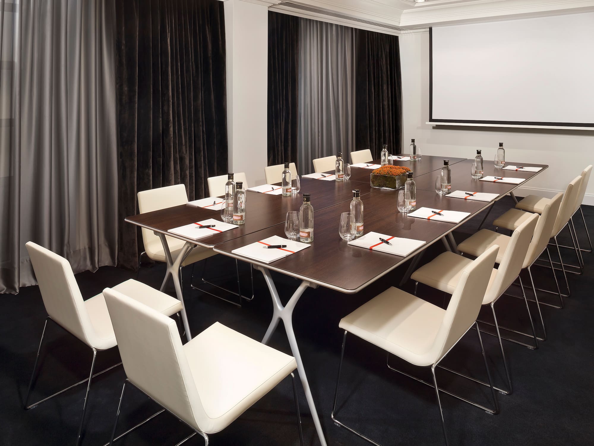 a conference room with a table and chairs