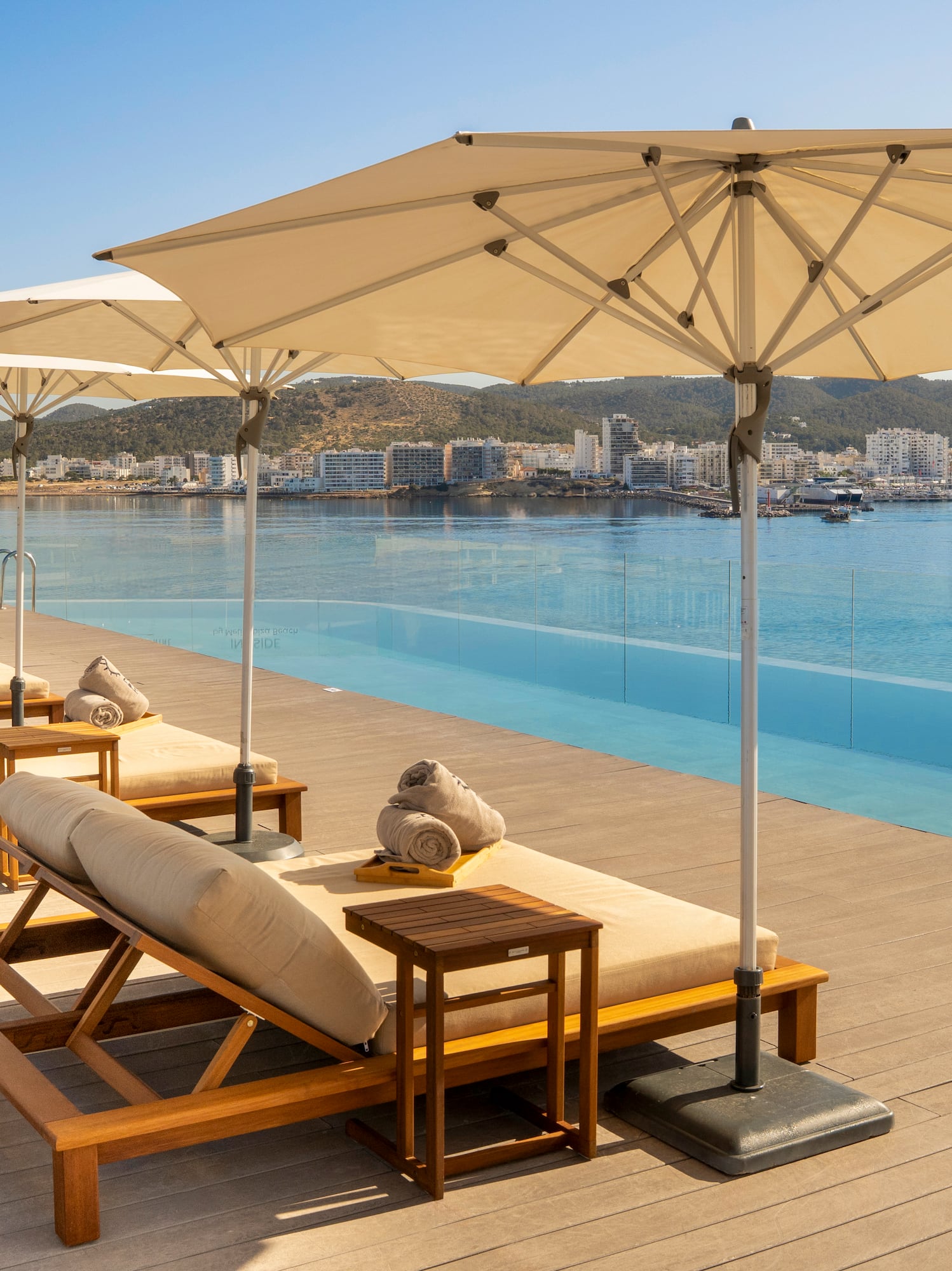 a pool with lounge chairs and umbrellas