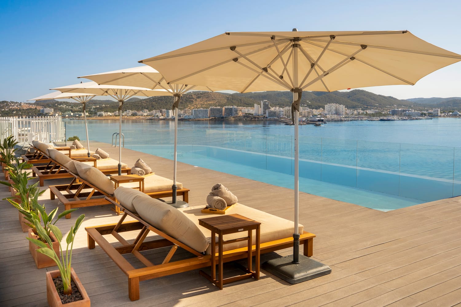 a pool with lounge chairs and umbrellas