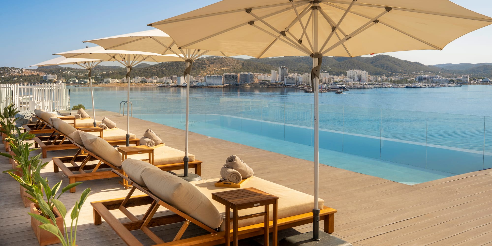 a pool with lounge chairs and umbrellas