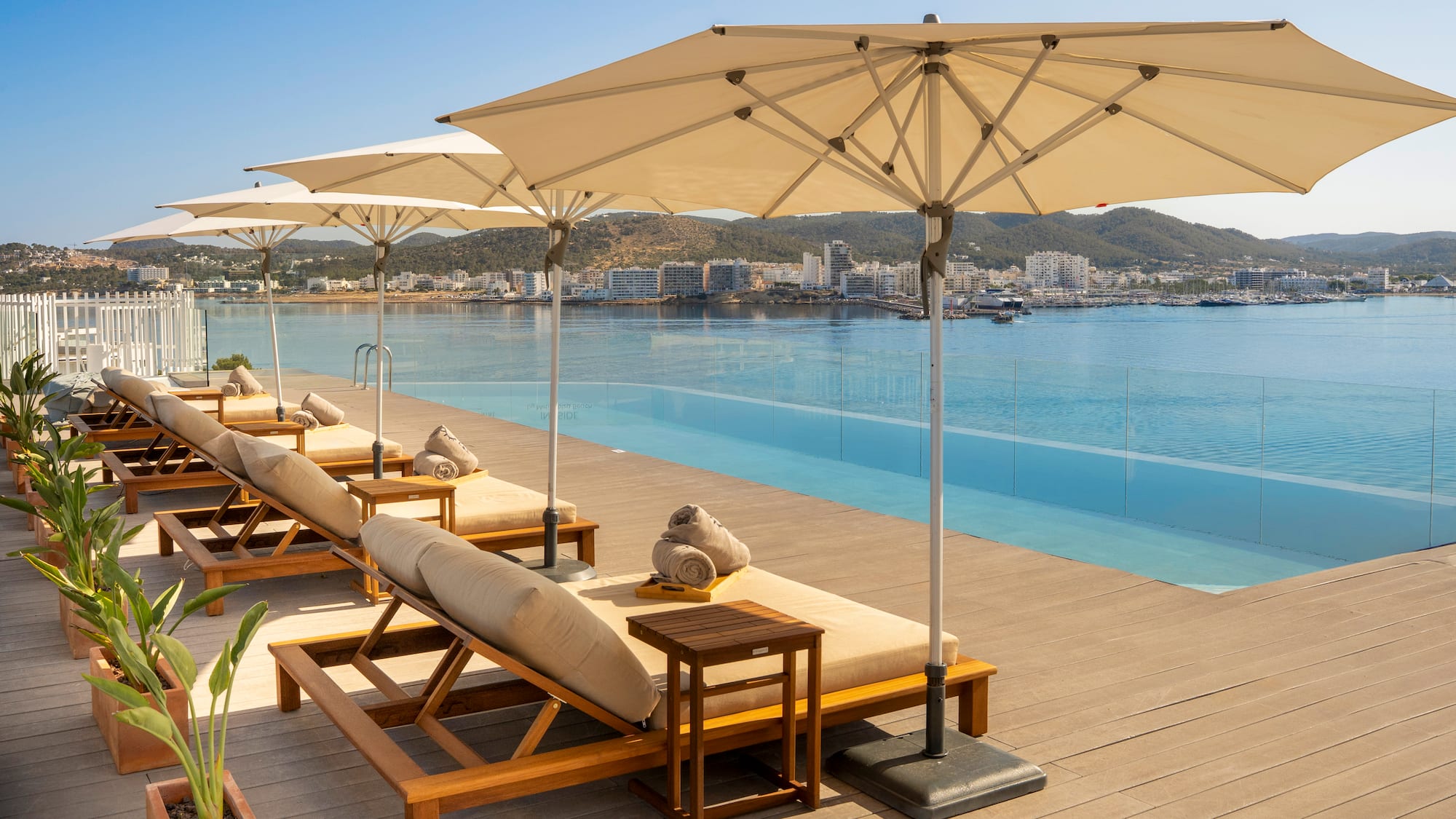 a pool with lounge chairs and umbrellas
