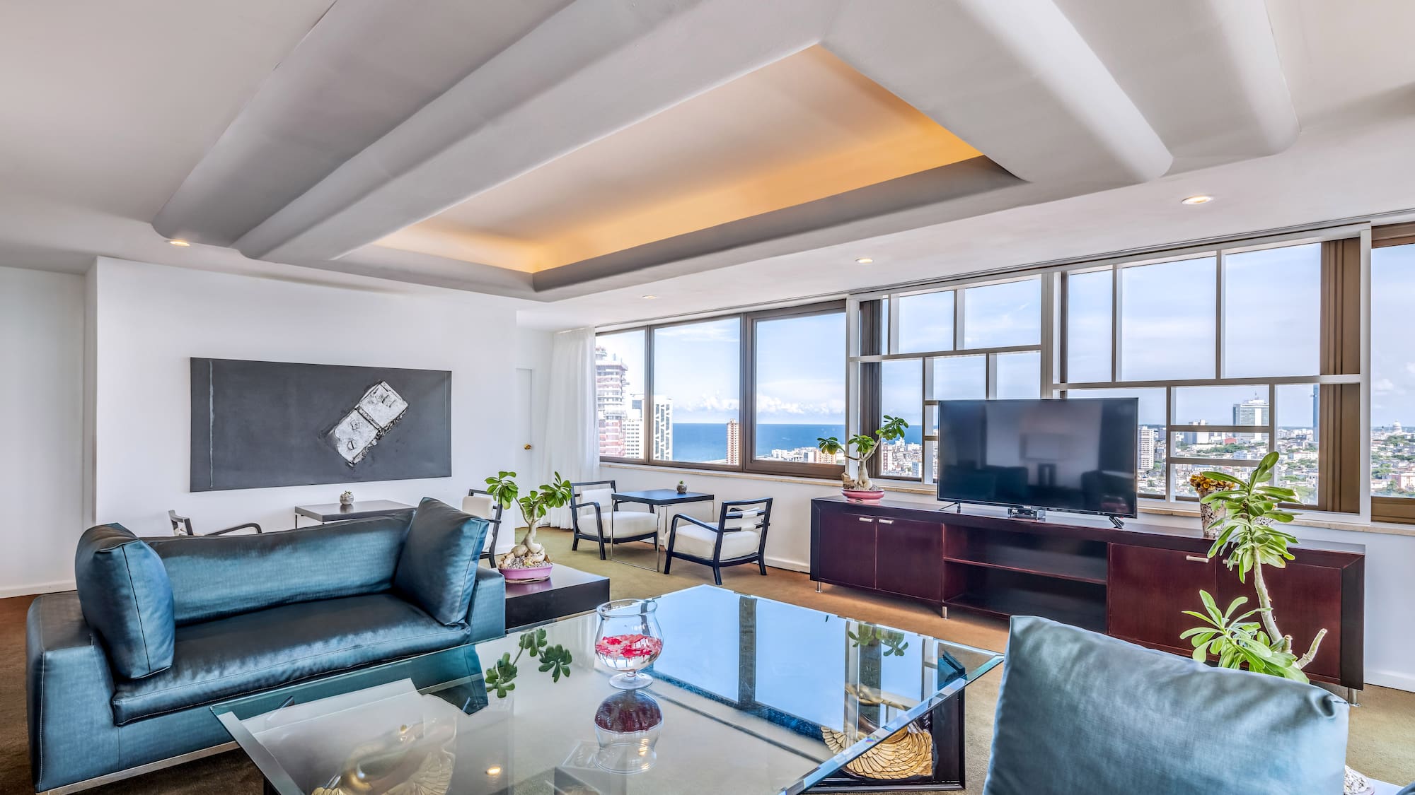 a living room with a glass table and a television
