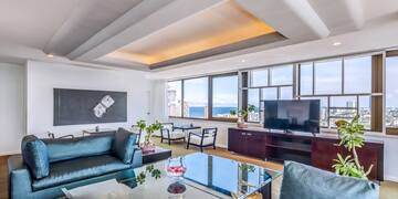 a living room with a glass table and a television
