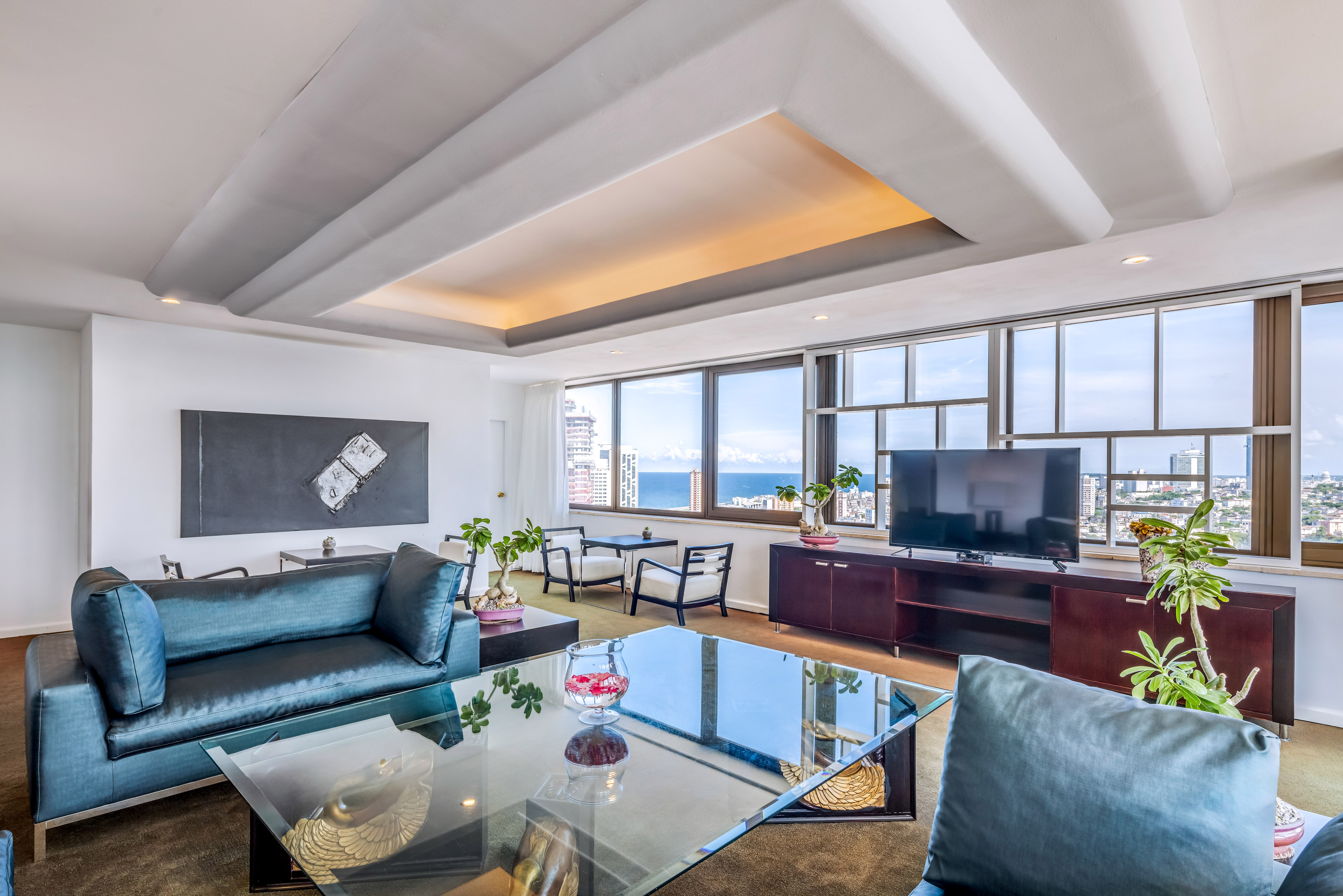 a living room with a glass table and a television