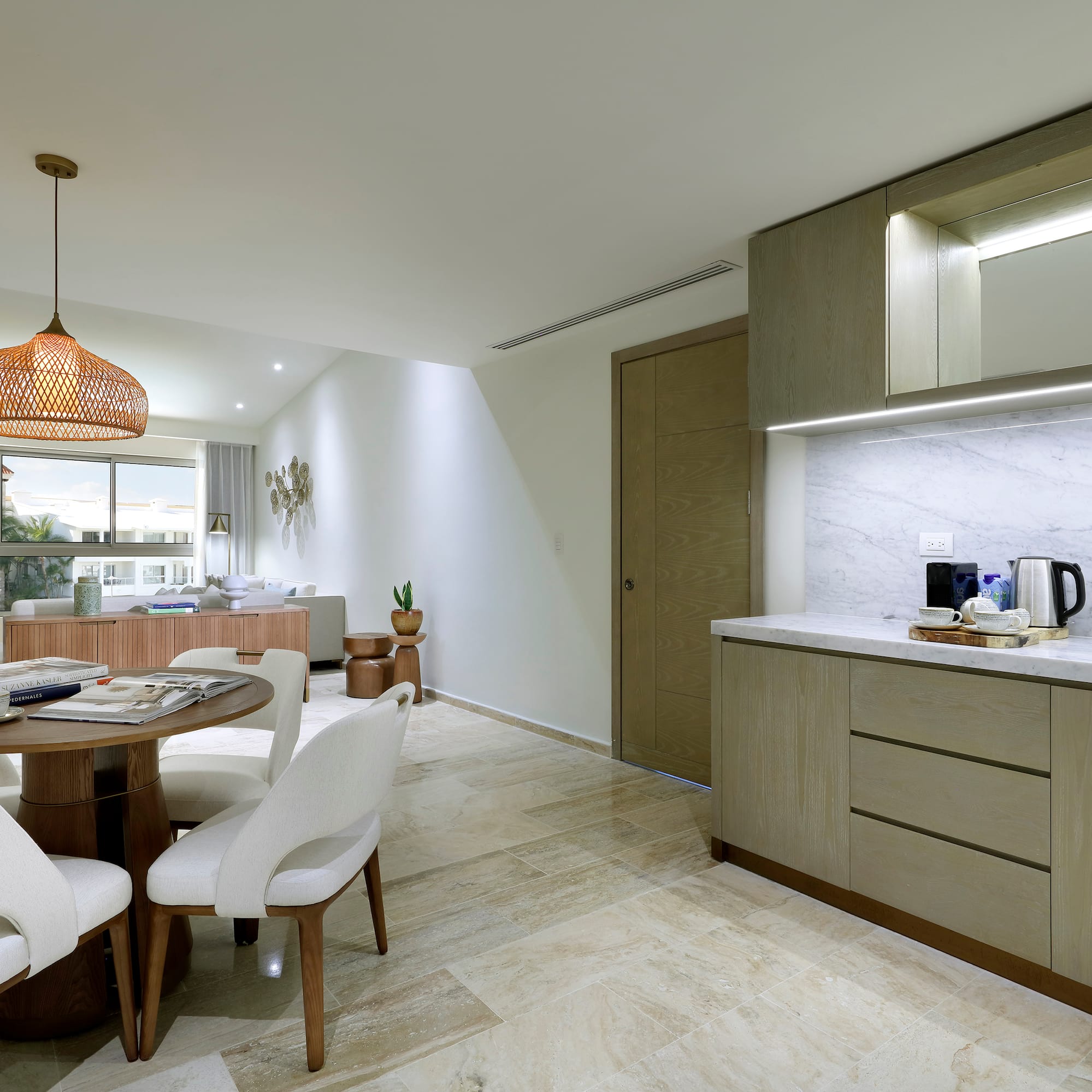 a kitchen and dining room with a table and chairs