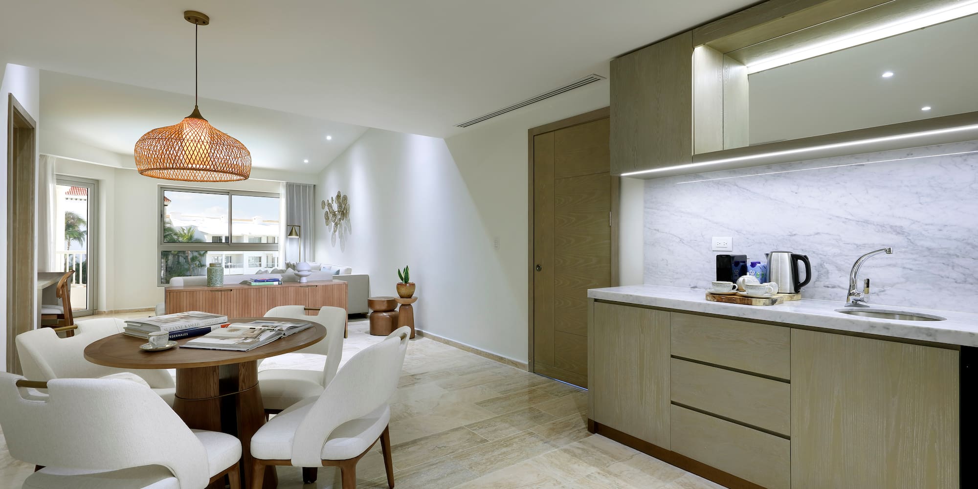 a kitchen and dining room with a table and chairs