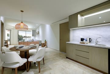 a kitchen and dining room with a table and chairs