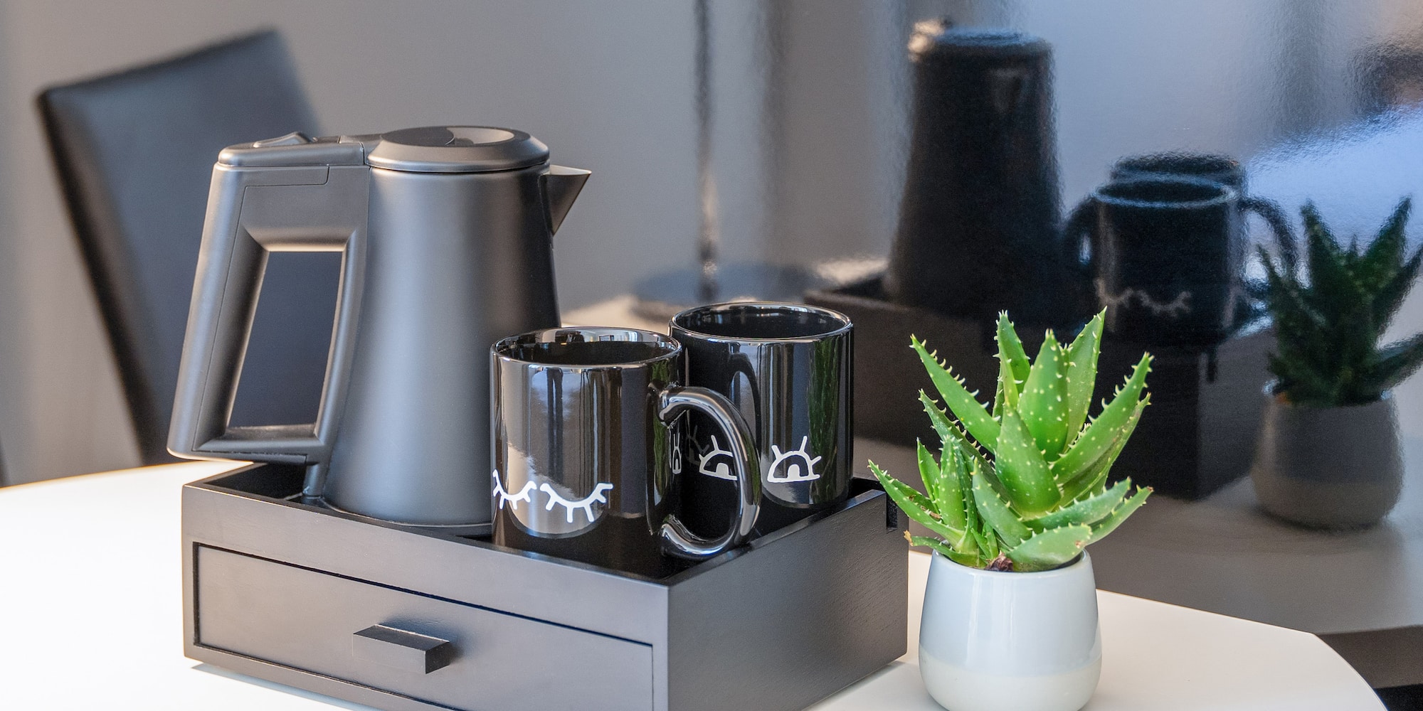 a coffee pot and coffee maker on a tray