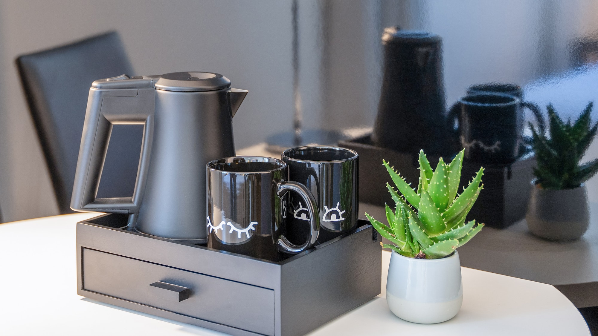 a coffee pot and coffee maker on a tray