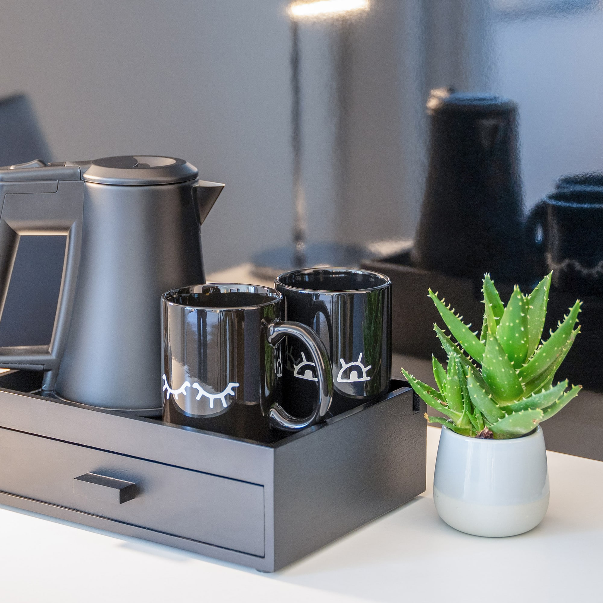 a coffee pot and coffee maker on a tray