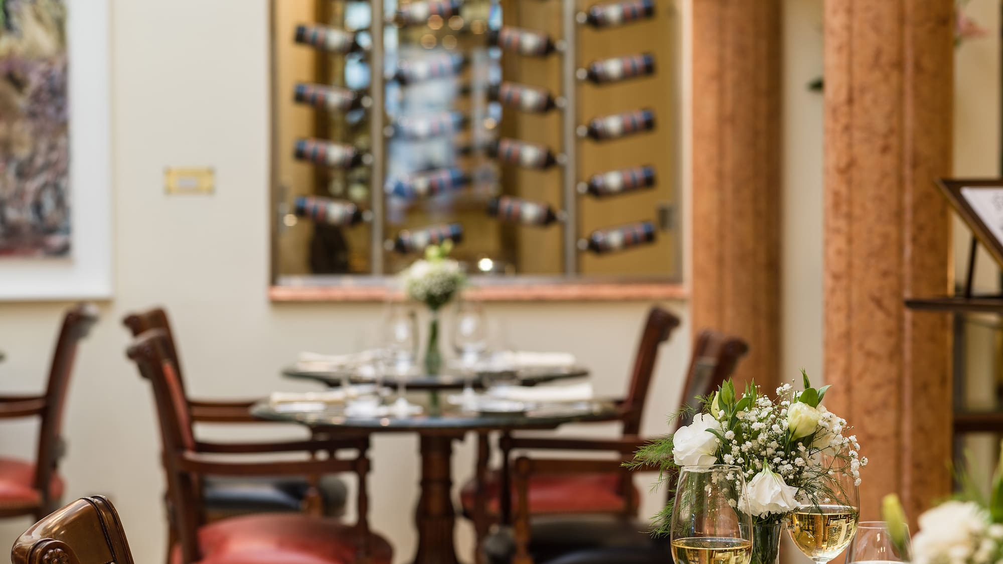 a table with wine glasses and flowers on it