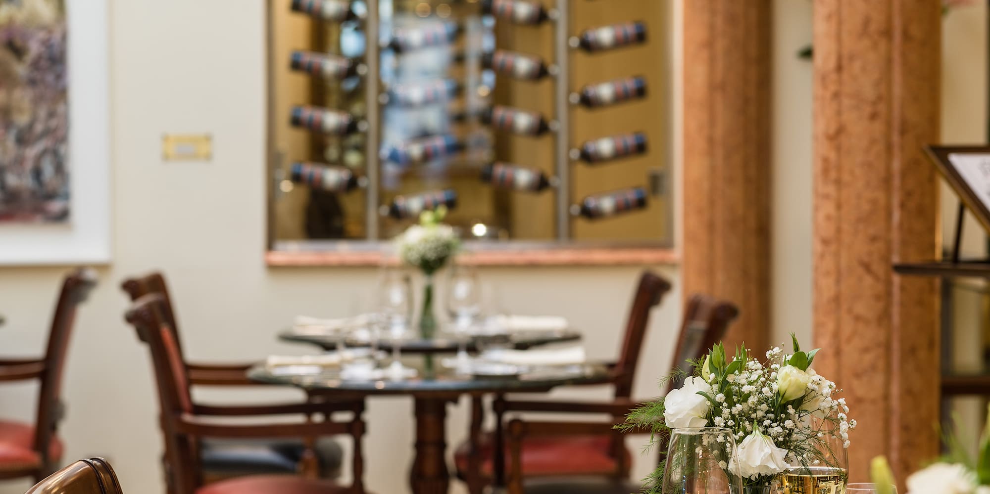 a table with wine glasses and flowers on it