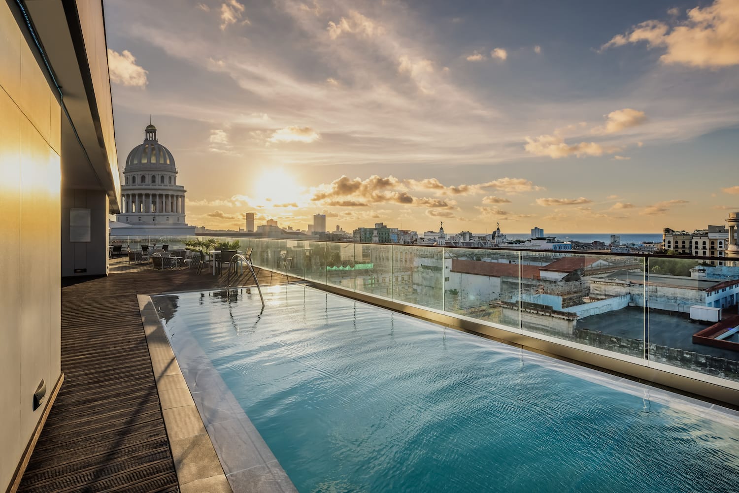 a pool on a rooftop overlooking a city