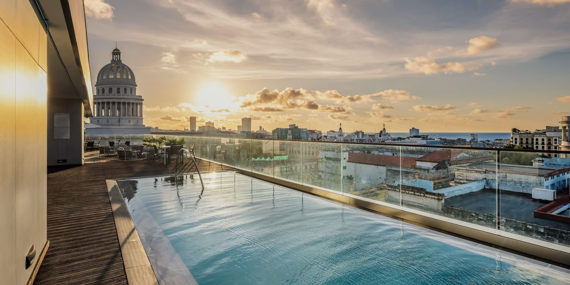 a pool on a rooftop overlooking a city