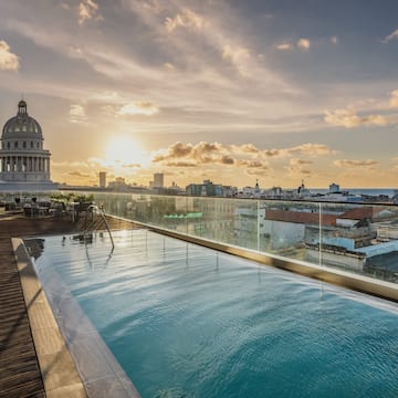 a pool on a rooftop overlooking a city