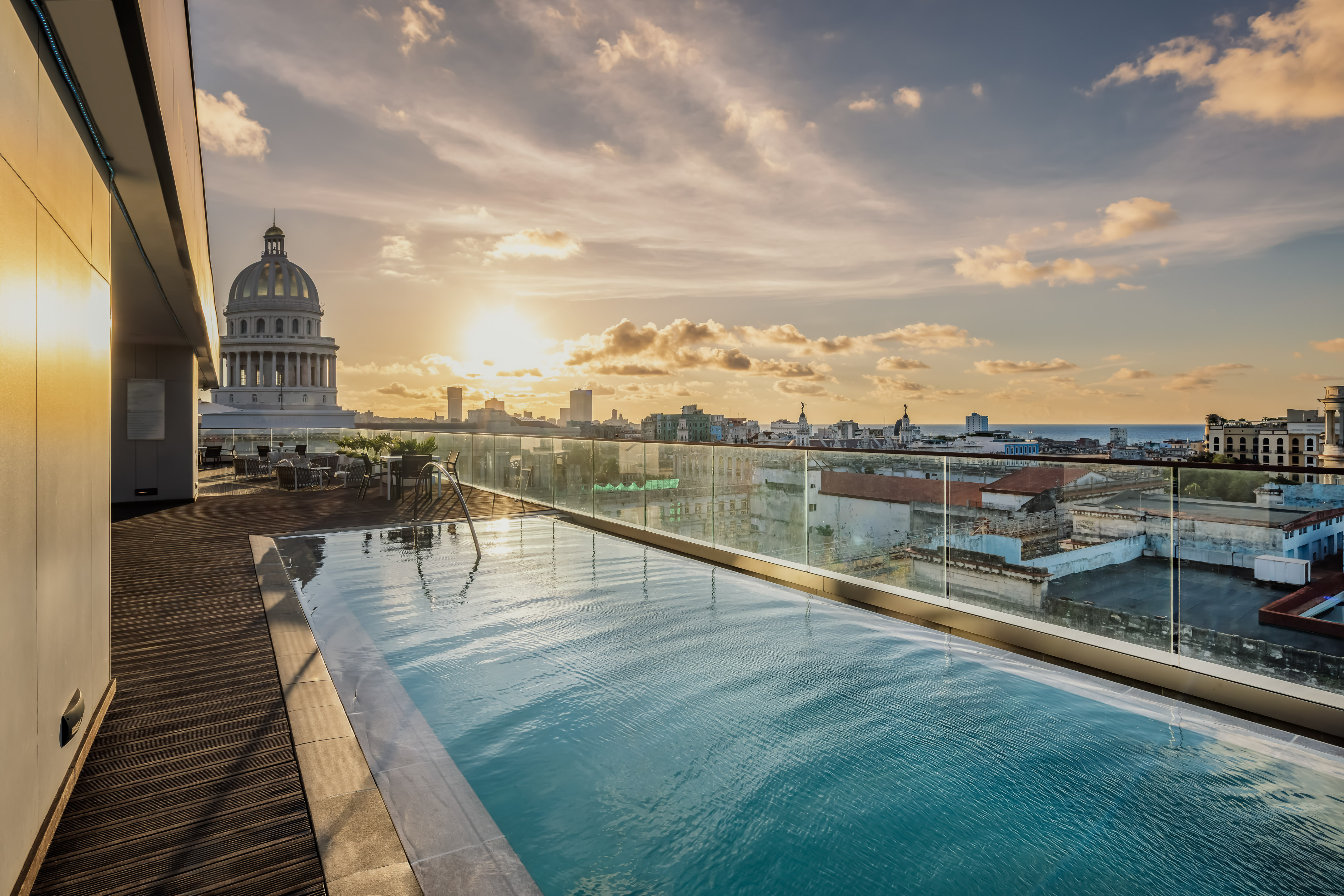 a pool on a rooftop overlooking a city