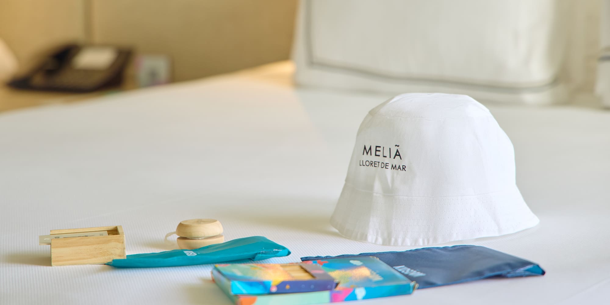 a white hat and other items on a bed