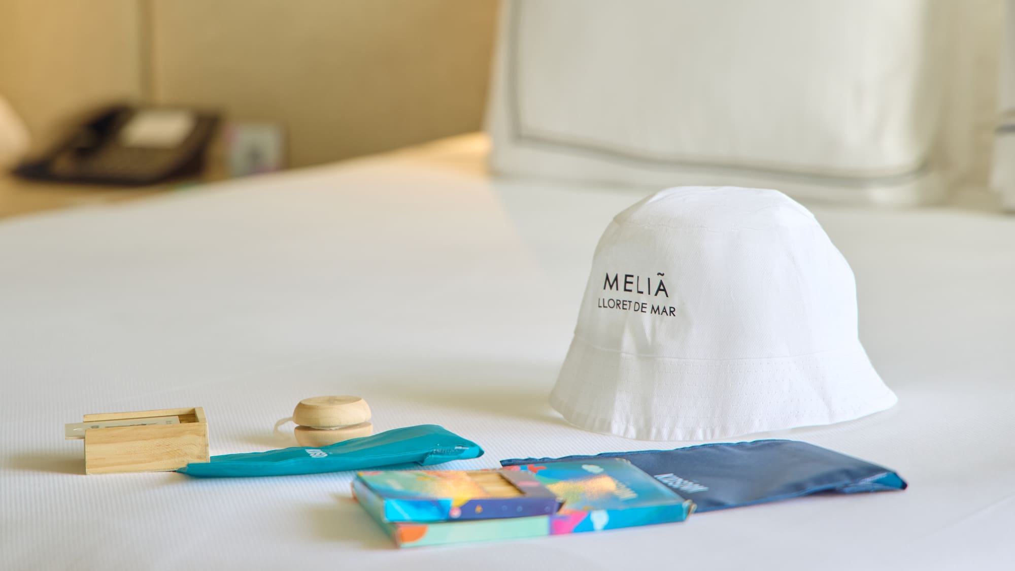 a white hat and other items on a bed